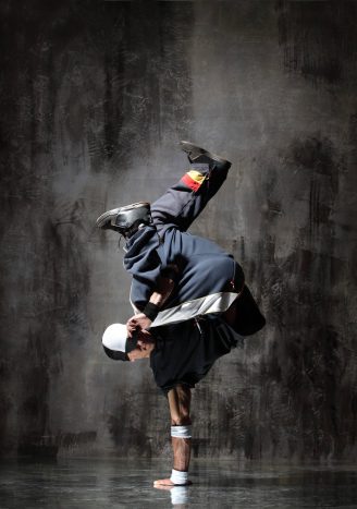 modern style dancer posing on dirty grunge background