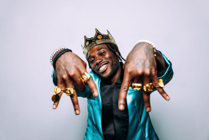portrait of an hip hop music musician. Cinematic image of a man wearing party clothes and jewels
